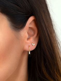 "Beautiful and classy, these tiny baguette hoop earrings are adorned with a dainty baguette charm. Layer these versatile huggie hoops with other delicate earrings to create your favourite ear stack. * Sold individually (1 hoop) or by pair (2 hoops). Both options are available on the dropdown menu. * Available with an emerald green, white or black cubic zirconia gemstone. All options are available on the dropdown menu. * D E T A I L S * ∙ Material: .925 Sterling Silver or 18K Gold Plated over .92 Earring Ideas 2 Holes, Seconds Ear Piercing Silver, 2nd Hole Ear Piercing, Ear Piercings First And Second, Double Ear Piercing Ideas Silver, 2 Ear Piercings Silver, Dainty Huggie Earrings, Baguette Huggie Earrings, 2 Earrings Piercings Silver