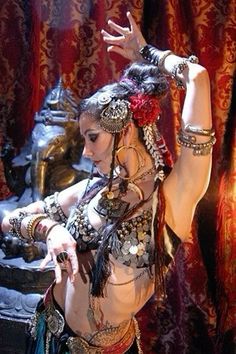 a belly dancer is posing for the camera