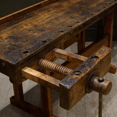 an old wooden work bench with tools attached to it