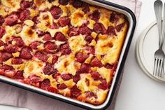 a close up of a casserole with strawberries on it