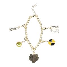 PRICES MAY VARY. Officially licensed Hufflepuff charm bracelet for fans of the Hogwarts house. This bracelet features 5 different house-themed charms with enamel fill details and glass gems. The shiny gold metal finish adds an elegant touch to your wrist. Mix and match the charms to create a unique bracelet that showcases your Hufflepuff pride. The bracelet is adjustable, with a length of 180mm and a 30mm extender for a comfortable fit. Show your Hufflepuff pride with this officially licensed Hu Harry Potter Memorabilia, Harry Potter Lego Sets, Interchangeable Bracelet, Harry Potter Set, Hufflepuff Pride, Harry Potter Hufflepuff, Harry Potter Merchandise, Trending Bracelets, Glass Gems