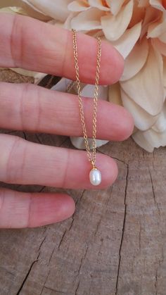 This delicate necklace is just perfect to wear on its own or layered with your favourite pieces! Pearls are also the birthstone of anyone born in the month of June. D E T A I L S *It features a single AA grade cultured white teardrop pearl. These measure between 4 and 5mm and have a smooth, even nacre. *It is suspended from a super dainty  stainless steel chain. Chain is available in 14k gold, rose gold and silver. *Stainless steel is very hard wearing and will not tarnish or oxidise. It is also amazingly hypoallergenic. *Necklace comes with a crystal information card and is ready for gifting. S I Z I N G * H E L P To ensure you get the right size measure your neck with a piece of string where you would like your necklace to sit. Then with a ruler or measuring tape measure your string. Thi Pear-shaped Drop Necklace With Pearl Chain For Gift, Dainty Pearl Chain Jewelry With Teardrop Pendant, Minimalist Teardrop Pearl Chain Necklace, Dainty Pearl White Necklace, Pearl Chain Drop Necklace With Teardrop Pendant For Gift, Rose Gold Teardrop Necklace With Pearl Pendant, Delicate Briolette Pearl Necklace Gift, Delicate Pearl Chain Charm Necklace As A Gift, Pear-shaped Necklace With Pearl Charm As Gift