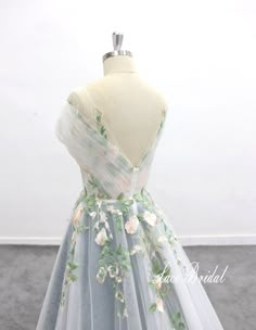 a dress on a mannequin with flowers on it