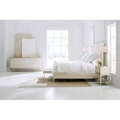 a bedroom with white walls and furniture