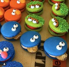 there are many cookies and cupcakes that look like sesame street characters on the table