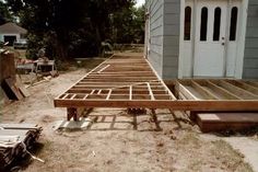 a wooden bench sitting in the middle of a yard