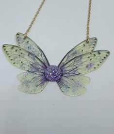 Discover the new magnificent collection of resin fairy wing necklaces. They have been created with love to add a magical and magical touch to your day! *The fairy wing necklace was created by me in my magical workshop. The necklace has a stainless steel chain adjustable by an extension chain. These high-end jewelry pieces are both elegant and durable. *The magical and magical fairy wings are made from resin which is a delicate but sturdy material once hardens. A certain light and shine has been Handmade Fairy Jewelry For Party, Handmade Fairy Style Jewelry For Parties, Fairy Style Handmade Jewelry For Parties, Iridescent Fairy Jewelry For Parties, Iridescent Fairy-style Jewelry For Parties, Iridescent Fairy Style Jewelry For Party, Handmade Fairycore Necklaces For Party, Fairycore Butterfly Necklace As A Gift, Fairycore Butterfly Necklace For Gift