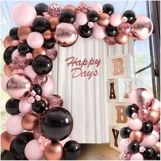 a happy birthday balloon arch with black, pink and gold balloons