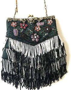 Multicolor Beaded Evening Bag with Flapper Style Fringe, Antique Brass Clasp and Floral Pattern rhinestones on front side.   Beads are lavender, burgundy, copper, peach red, white, blue and green. Pocket for ID inside. Antique brass chain is included, but optional.  Extra beads are included.  (See photos) Bag is 9 inches long, 8 inches wide and approximately 1 inch deep.   Fabric is soft sided and flexible allowing bag to hold several things. This bag appears to be new.  I can find no sign of we Formal Rectangular Bags With Beaded Fringe, Formal Rectangular Bag With Beaded Fringe, Multicolor Beaded Bag For Evening, Luxury Beaded Fringe Evening Bag, Multicolor Beaded Rectangular Evening Bag, Holiday Clutch, Vintage Multicolor Beaded Evening Bag, Vintage Beaded Clutch Bag, Hand Embroidered Pillows