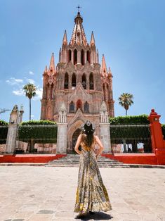 a woman standing in front of a tall building