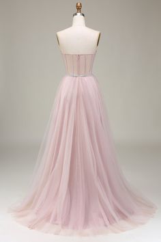 a dress on a mannequin with a pink tulle skirt and beaded belt