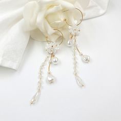 "Beautiful wedding flower earrings - dangle and drop earrings The earrings are made of artificial flowers, pearls, chains, and other trinkets used for arranging. #1   - Total 4.5\" long - 1\" (20mm) outer diameter C post Hoop - 0.4\" Flowers - 0.4\" W x 0.6\" H teardrop pearl - 0.65\" long faceted crystal bead #2  - Total 3.15\" long - 1\" (20mm) outer diameter C post Hoop - 0.4\" Flowers" Pearl Flower Dangle Earrings For Pierced Ears, Pearl Flower Charm Drop Earrings, Dangle Earrings With Flower Charm For Party, Party Flower Charm Dangle Earrings, Party Dangle Earrings With Flower Charm, Pearl Charm Drop Flower Earrings, Pearl Flower Drop Earrings With Pearl Charm, White Flower-shaped Earrings With Pearl Charm, Dangle Earrings With Flower Decoration For Party