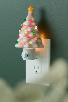 a white light switch with a christmas tree on it