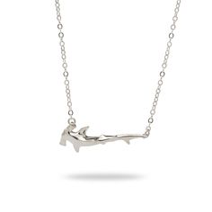 a silver necklace with a shark on it