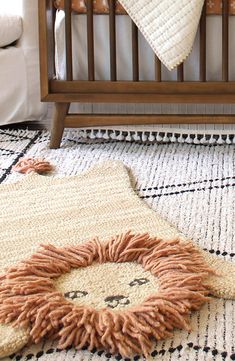 a baby crib with a teddy bear on the floor