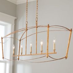 a chandelier with candles hanging from it