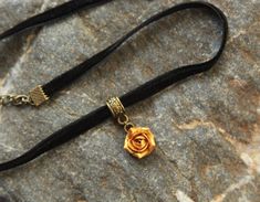 "Skinny velvet ribbon choker with sculpted gold metallic rose. Rose material is polymer clay with special strong metallic cover. Each petal of flower made by hand without any mold Dia flower about 12 mm/ 0.4 \" Length of necklace is adjustable: 10-12 inches/ 25,4 - 30,5 cm 11-13 inches/ 28-33 cm 12-14 inches/ 30.5- 35.5 cm 13-15 inches/ 33-38 cm 14-16 inches/ 35.5 cm-40.5 cm 15-17 inches/ 38,1 cm- 43,2 cm 16-18 inches/ 40.6 cm- 45.7 cm 17-19 inches/ 43 cm - 48 cm 18-20 inches/ 40,5- 50,8 cm Widt Adjustable Rose Gold Choker, Adjustable Rose Gold Choker For Party, Adjustable Gold Rose Design Jewelry, Adjustable Rose Gold Party Choker, Adjustable Rose Choker Necklace, Gift Rose Design Choker In Rose Color, Adjustable Rose Design Choker Necklace, Rose Design Choker As Gift, Flower Necklace Gold