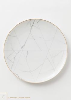 a white marble plate with gold trim