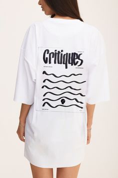 Elevate your casual style with our white cotton oversized T-shirt, featuring a bold "Critiques" print on the back. Perfect for those who embrace the power of feedback and growth, this tee offers a relaxed, oversized fit with lowered shoulders for a modern, laid-back silhouette. Made from soft, high-quality cotton, it provides all-day comfort, whether you're out exploring or simply lounging at home. The minimalist yet striking "Critiques" print adds a thoughtful edge to your wardrobe, making it a White Drop Shoulder T-shirt With Graphic Print, Oversized White Graphic Print T-shirt, Oversized White Tops With Screen Print, Oversized White Top With Screen Print, Oversized White Print Cotton T-shirt, Oversized White T-shirt With Logo Print, White Tops With Graphic Design For Everyday, White Graphic Design Tops For Everyday Wear, White Graphic Design Top For Everyday