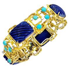 This unique and colorful chunky gold link bracelet is a captivating work of art, seamlessly blending geometric precision with the allure of natural gemstones. Each alternating link showcases a cushion-cut lapis lazuli gemstone, masterfully carved to reveal intriguing ridged accents on their surfaces. These lapis lazuli stones add an air of mystique to the piece, their deep blue hues punctuated by the organic textures of the ridges. The yellow gold links are crafted into a mesmerizing geometric pattern, evoking a sense of structured elegance. The bold, square shapes of the gold contrast beautifully with the organic, round cabochon-cut turquoise and delicate round diamonds that are thoughtfully interspersed. The diamonds and turquoise inject this piece with bursts of color and sparkle, creat Organic Textures, Genie Bottle, Gold Link Bracelet, Lapis Lazuli Gemstone, Lapis Lazuli Stone, Gold Link, Yellow Gold Bracelet, Blue Hues, Diamond Clarity