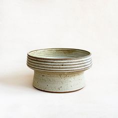 a white and gray bowl sitting on top of a table