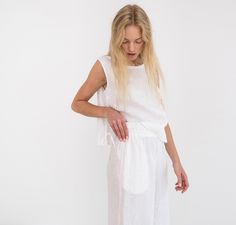 "AVERY is a linen tank top with side ties. DETAILS - Sleeveless design - Crew Neck - Side Ties - Straight cut - 100% lightweight European linen fabric - Cut and sewn to order just for you in our studio COLOR - White (slightly see through), you can also choose other colors above - Fabric samples are available here https://www.etsy.com/listing/586569696/linen-fabric-samples SIZING & FIT - Fits true to size - Length is approximately 19 inches / 48 cm - Bust is approximately 19 inches / 48 cm - Linen Sleeveless Top, Wide Leg Linen Trousers, Linen Dress Summer, Sleeveless Linen Dress, Linen Crop Top, Studio Color, Linen Tank Top, Linen Crops, Linen Tank