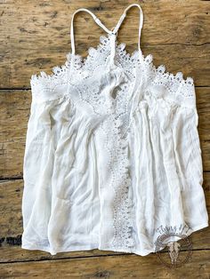 Upgrade your summer wardrobe with this delicate White Lace Trim Cami. Crafted from soft and airy fabric, this top features a beautiful lace trim, adding a touch of sophistication and femininity. Dress it up or dress it down and look effortlessly chic in any occasion. ** Only 1 ** + Size Small + Runs true to size. This is a loose flowy top Summer V-neck Tops With Crochet Lace, Elegant V-neck Crochet Top For Summer, Elegant V-neck Crochet Top With Lace Trim, Chic V-neck Lace Top For Daywear, Feminine V-neck Lace Top For Summer, Chic Cami Blouse For Summer, Chic Summer Cami Blouse, Lace V-neck Top With Crochet Trim, Lace V-neck Camisole For Vacation