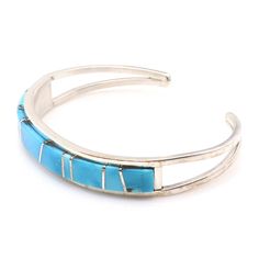 Experience the exquisite craftsmanship of Navaho artist Sam Arviso with this handcrafted Turquoise channel inlay bracelet. Measuring 5 1/4" from tip to tip with a 1" opening, this bracelet is expertly crafted and not easily adjustable. Its sleek 3/8" width and weight of approximately 17.4 grams make it a stunning addition to any jewelry collection. Adjustable Turquoise Inlay Bracelets, Adjustable Turquoise Bracelet With Inlay, Adjustable Blue Inlay Cuff Bracelet, Adjustable Blue Cuff Bracelet With Inlay, Make It, Jewelry Collection, Sleek, Thing 1, Turquoise