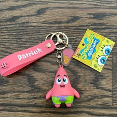 a pink keychain with a cartoon character on it