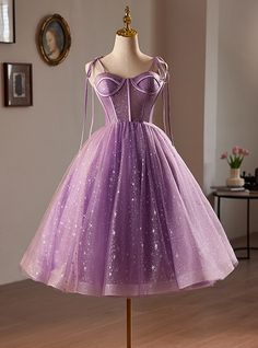 Metamorphose into the belle of the ball in this stunning lavender homecoming dress. Impeccably crafted from layers of light-catching tulle, this dress shines with embedded glitter and delicate starry patterns throughout. The bodice is expertly designed with corset-like detailing, enhancing your silhouette, while the flowing skirt invites twirls and dances under the homecoming lights. Adjustable straps ensure a perfect fit, making you feel as fabulous as you look. This dressromantic allure is heightened by its dreamy color and the subtle glimmers that suggest a galaxy of possibilities. Whether you're posing for pictures or dancing the night away, this dress is your ally for an unforgettable homecoming experience. Short Sleeve Prom Dress, Lavender Homecoming Dress, Tea Length Homecoming Dresses, Purple Prom Dress Short, Short Sleeve Prom Dresses, Sleeve Prom Dress, Purple Prom, Purple Prom Dress, Short Prom Dress