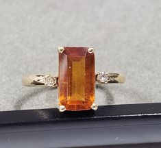 -PRODUCT TYPE - 14k GOLD ORANGE GARNET RING -MATERIAL - GOLD 14K -PURITY - 14K -STONE WEIGHT - 3.45 CARAT       -DIAMOND WEIGHT - 0.04 CARATS APPROX               -GOLD WEIGHT - 2.852 GRAMS APPROX -TOTAL WEIGHT - 3.550 GRAMS APPROX -STONE - ORANGE GARNET -STONE SIZE - 6 X 11 MM    -BAND SIZE - 2 MM We are Introducing this new collection of Gold jewelry which is distinctive and unique. We have used natural Orange Garnet of superb quality. So, here We launch this item on etsy!  If You are looking for any other sizes which are not available in variation category do contact us directly.  Anirudh Gems Store :- https://www.etsy.com/uk/shop/ANIRUDHGEMSStore?ref=search_shop_redirect -Quality is guaranteed. Our mission is always to satisfy our customers with our offerings, so just relax and place o Gem Store, Garnet Gem, Solid Gold Ring, Garnet Ring, Bridal Bands, Garnet Stone, Solid Gold Rings, Women Ring, Gold Orange