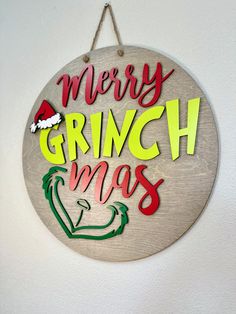 a merry grinch christmas sign hanging on the wall