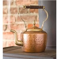 a copper tea kettle sitting on top of a stove