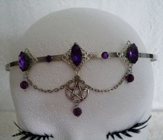 This beautiful circlet has three sterling silver plated filigree accents with purple faceted glass settings, purple faceted bead drops, rhinestones, pewter silver pentacle and metal chain. Adjustable. Bohemian Adjustable Headband With Round Crown, Handmade Silver Fantasy Body Jewelry, Adjustable Nickel-free Gothic Body Jewelry, Silver Gothic Headpiece For Festivals, Gothic Adjustable Body Jewelry For Halloween, Adjustable Gothic Body Jewelry For Halloween, Adjustable Silver Gothic Body Jewelry, Adjustable Gothic Jewelry For Festivals, Adjustable Fantasy Headband With Round Crown