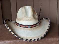 A hat for all occasions! The hat body is a very soft hat and has been flame distressed. The brim is 4" and has a wire in it to shape it further. The crown is 5". This hat has stampede strings so it stays on in those high winds. Hand laced in brown leather The layered hat band is brown leather with Southwestern imprinted whiskey brown leather and accented with sunburst sliders and nailspots. The back of the band has a deer antler bead. Finished with a long Ringneck Pheasant feather and smaller ph Western Curved Brim Hat For Rodeo, Country Style Top Hat With Curved Brim, Country Style Top Hat With Curved Brim For Ranch, Country Style Short Brim Hat For Rodeo, Country Style Curved Brim Hat For Ranch, Southern Style Hat With Short Brim For Western-themed Events, Western Brimmed Hat For Kentucky Derby, Adjustable Wide Brim Top Hat For Ranch, Country Style Brimmed Top Hat For Ranch