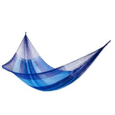 a blue hammock hanging on a white wall