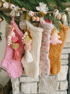 three knit stockings hanging from a mantel