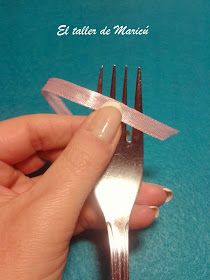 a person holding a fork with tape on it