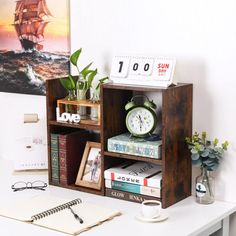 a desk with a clock and books on it