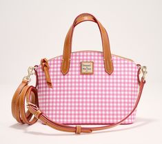 Worn on your shoulder or your arm, this pretty satchel makes a stylish statement. And thanks to the zipper closure, your belongings stay securely in place. From Dooney & Bourke. Pink Purses, Logo Line, Pink Purse, Dooney & Bourke, Novelty Print, Pretty Makeup, Crossbody Strap, Dooney Bourke, Favorite Color