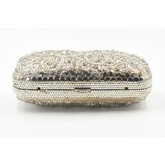 Elegant Judith Leiber silver metal and crystal oblong evening bag clutch featuring a scrolling foliage flower design on a silver - toned metal bag.  The hardware is silver.  It has a silver leather interior with a silver shoulder strap that can be folded inside when you want to wear it as a clutch.  There is a circle that folds out to hold a tassel, but it is no longer there.  Labeled ‘Judith Leiber/New York’ in the interior. 5.5” W x 3” H x 1.5” D  A similar one sold at Chrisities from Joan Riv Designer Silver Clutch For Formal Events, Designer Silver Clutch For Formal Occasions, Silver Evening Bag With Rectangular Case Shape, Silver Evening Bag Rectangular Case, Luxury Silver Clutch, Designer Silver Rectangular Clutch, Elegant Engraved Gold Bags, Luxury Evening Clutch With Silver-tone Hardware, Luxury Formal Clutch With Silver-tone Hardware