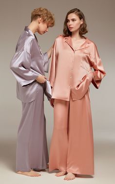 Immerse yourself in sumptuous comfort with our satin pajamas set, an elegant addition to your sleepwear repertoire. Artfully crafted from soft, breathable satin, this boutique-produced, limited-edition set marries style and comfort with finesse. The sophisticated button-up nightshirt exhibits a notch collar and voluminous sleeves, complemented by the wide-leg trousers with a button-front, pleated design and a semi-elastic waistband. This design-centric ensemble, perfect for restful nights and la Satin Night Suits, Satin Pajamas Set, Chic Loungewear, Night Suit For Women, Bridal Sleepwear, Stylish Pajamas, Satin Pyjama, Sleepwear Women Pajamas, Stylish Loungewear