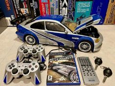 a toy car is on display with remotes and other items in front of it