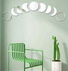 a green chair sitting next to a potted cactus