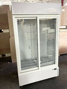 a large white refrigerator sitting inside of a room