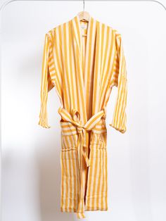 Add a touch of sunshine to your daily routine with the Girit Yellow Robe. This bright and cheerful robe, crafted from a soft cotton-linen blend, features bold yellow and white stripes, bringing a warm and vibrant feel to your mornings, spa sessions, or relaxation time. Perfect for lounging at home, by the pool, or as a stylish cover-up after a shower. The Girit Yellow Robe is designed for a comfortable and flattering fit. It is handwoven on semi-automated looms, showcasing traditional craftsmans Loungewear Sets, Daily Routine, All Seasons, Cotton Linen, Linen Blend, White Stripe, Hand Weaving, Cover Up, Lounge Wear