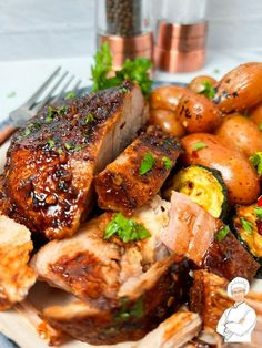 a plate with meat, potatoes and vegetables on it next to a glass of water