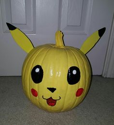 a pumpkin with pikachu's face painted on it