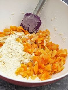 a bowl filled with different types of food and a whisk in the middle