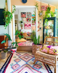 a living room filled with lots of plants and furniture next to a wall mounted clock